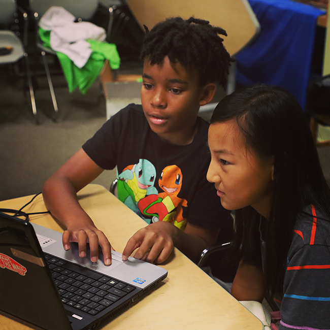 Two students coding together