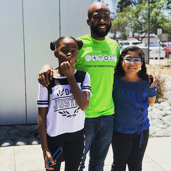 STEM founder with two students