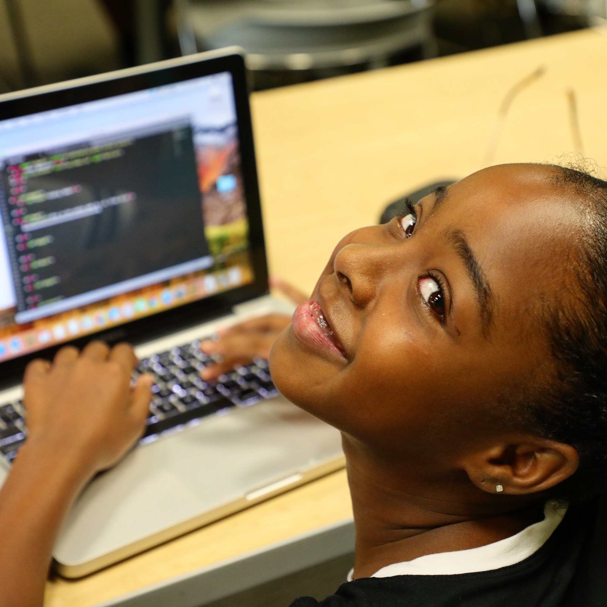 Girl smiling in front of laptop